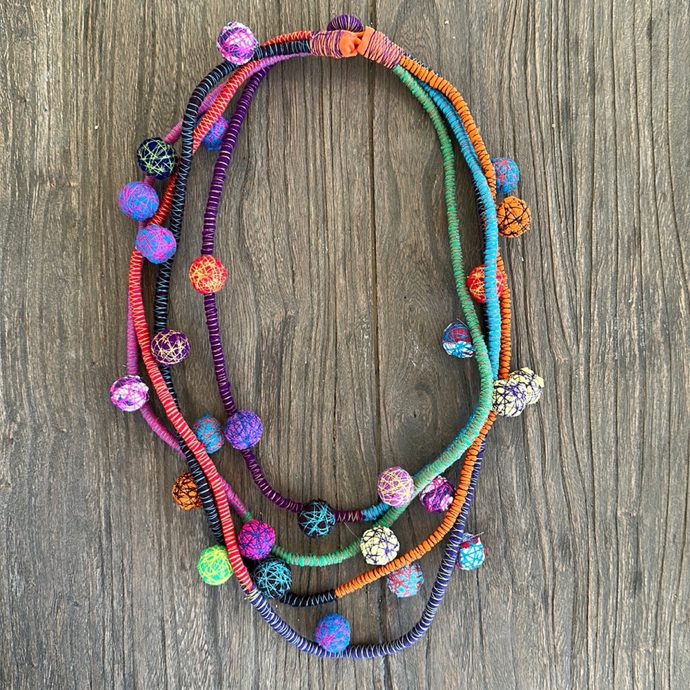 Bright colored multi strand felt necklace.